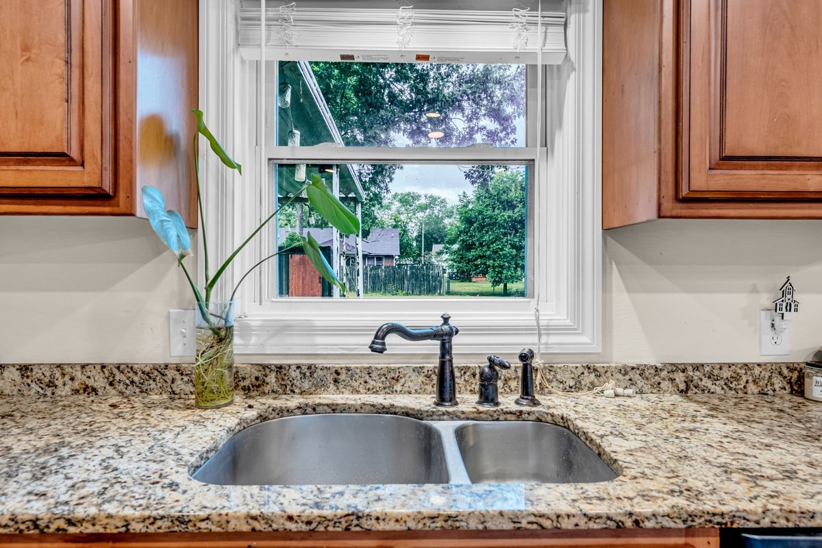207 East Fort Street Tullahoma, TN 37388 - Photo 12 of 45 a kitchen sink with a granite countertop a sink and a window