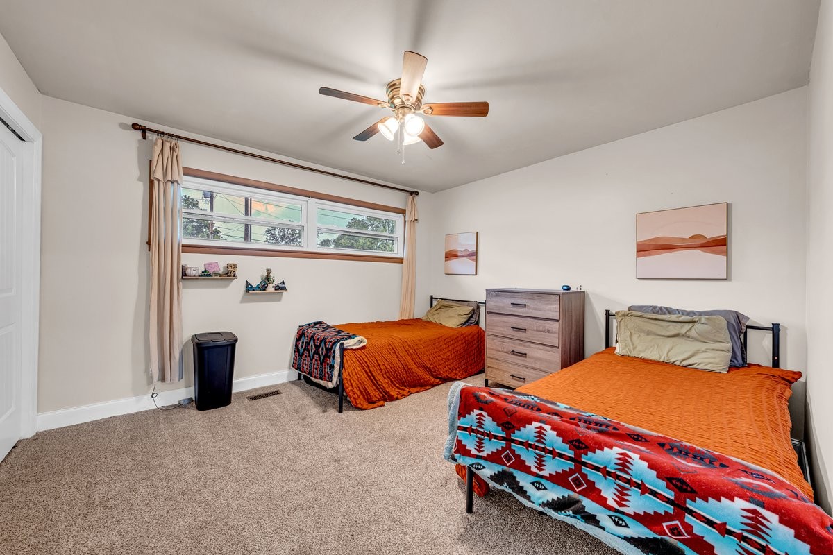 207 East Fort Street Tullahoma, TN 37388 - Photo 35 of 45 a bedroom with two beds and a chandelier