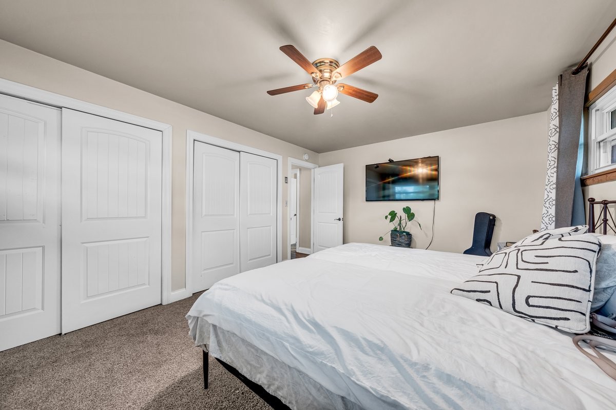 207 East Fort Street Tullahoma, TN 37388 - Photo 39 of 45 a bedroom with a bed and a chandelier