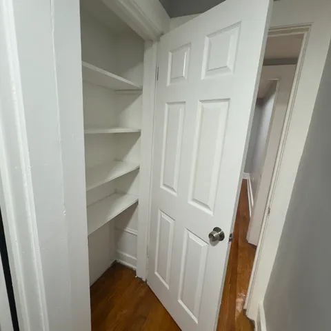 a bathroom with a toilet a sink a mirror and vanity