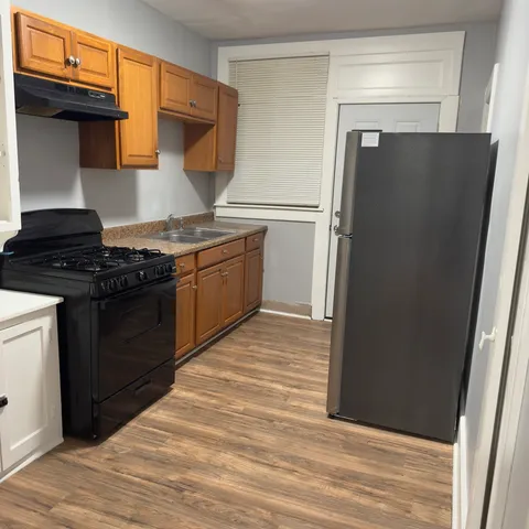a kitchen with a refrigerator and a stove