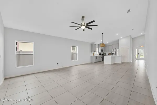 a bedroom with a bed and a ceiling fan