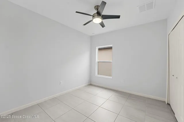 a bedroom with a bed and ceiling fan