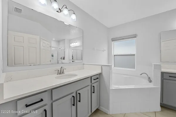 a spacious bathroom with a tub shower and sink