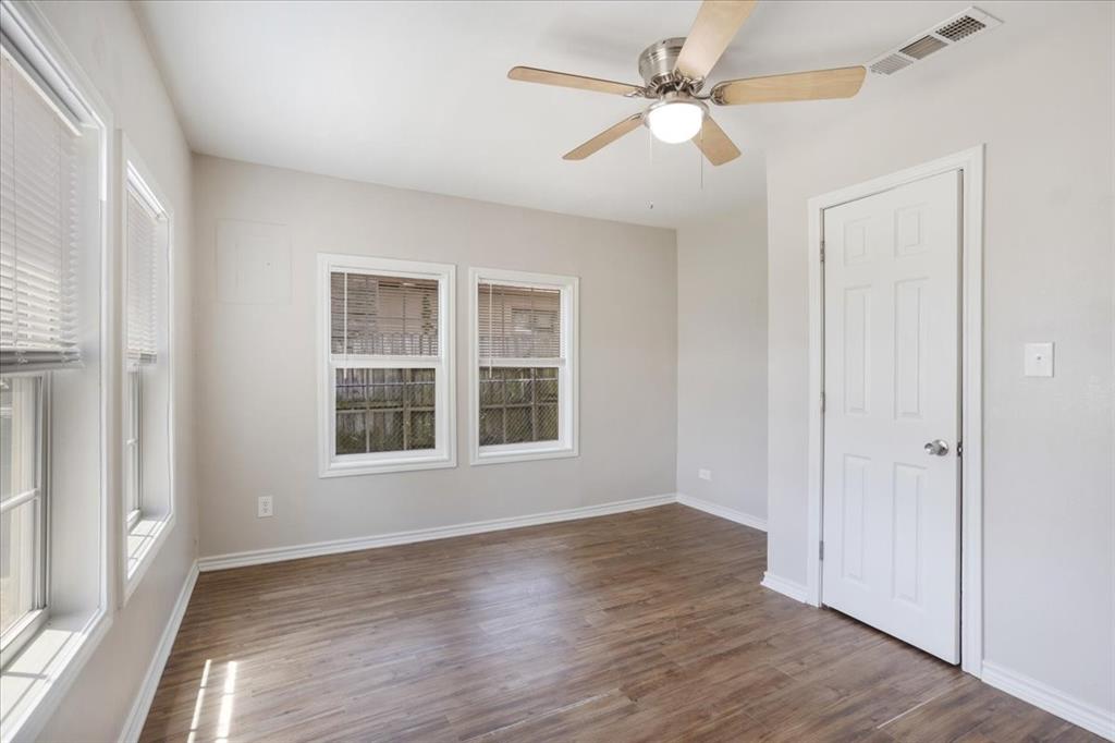 106 Cardinal Lane Pottsboro, TX 75076 - Photo 11 of 29 an empty room with wooden floor ceiling fan and windows