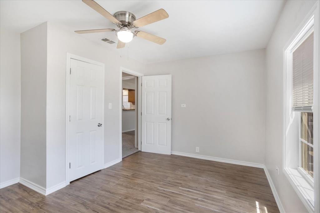 106 Cardinal Lane Pottsboro, TX 75076 - Photo 12 of 29 an empty room with wooden floor ceiling fan and windows
