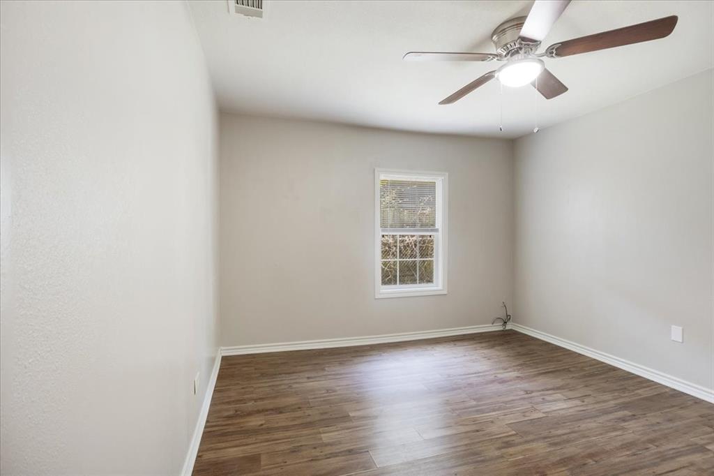 106 Cardinal Lane Pottsboro, TX 75076 - Photo 14 of 29 an empty room with wooden floor ceiling fan and windows