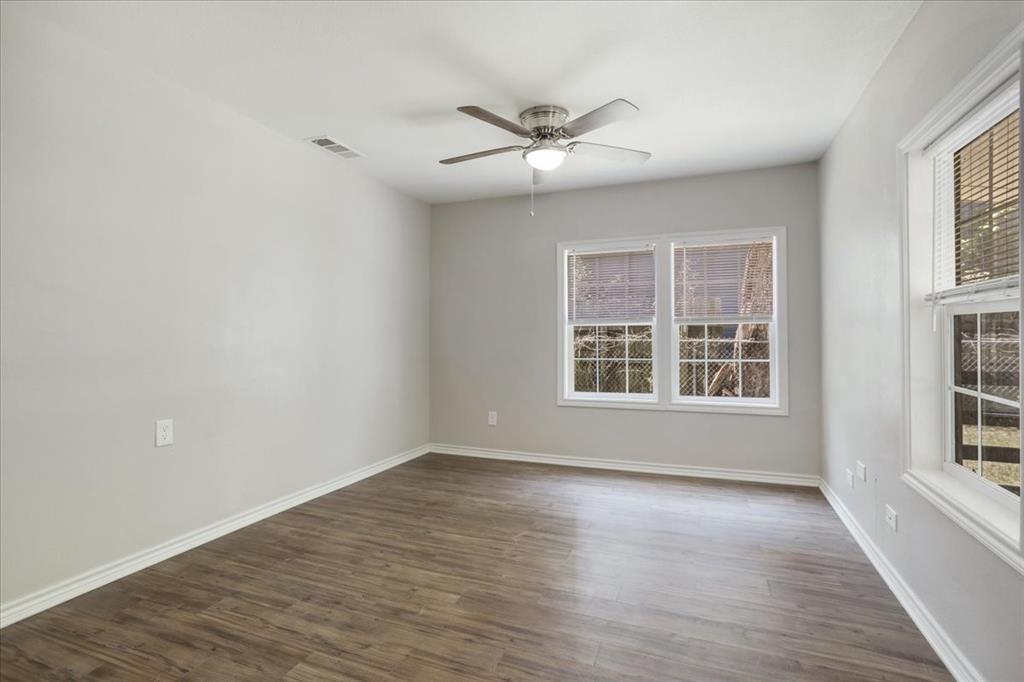 106 Cardinal Lane Pottsboro, TX 75076 - Photo 18 of 29 a view of an empty room with wooden floor and a window