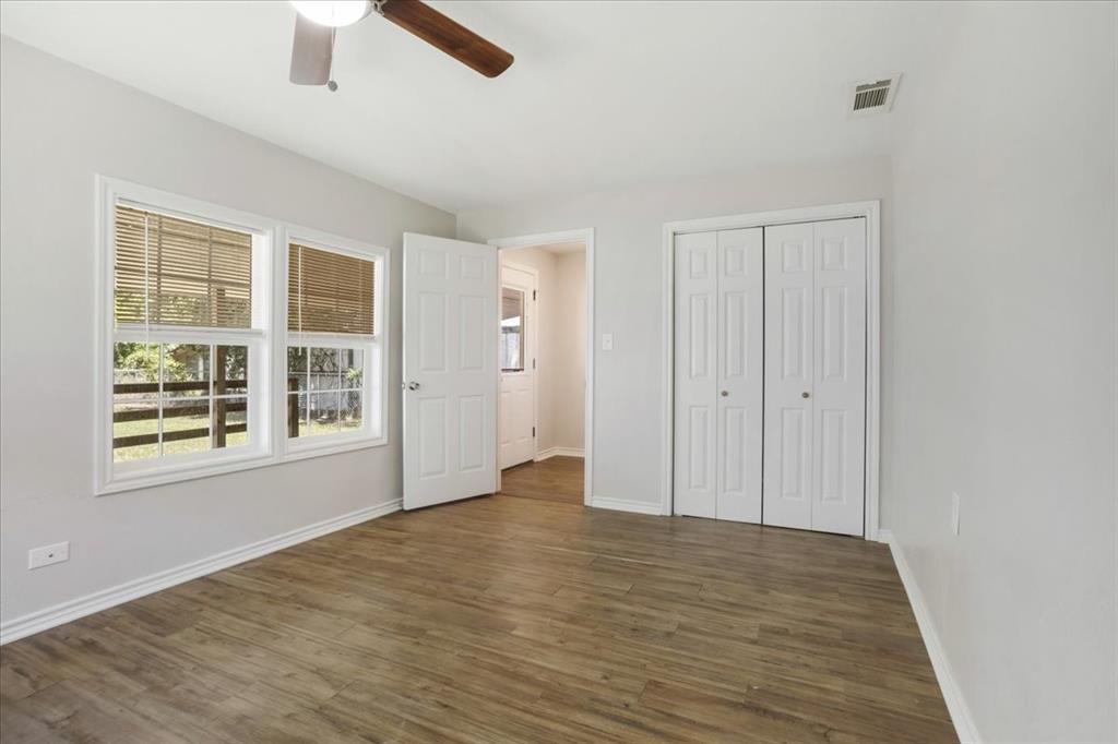 106 Cardinal Lane Pottsboro, TX 75076 - Photo 19 of 29 an empty room with wooden floor cabinet and windows
