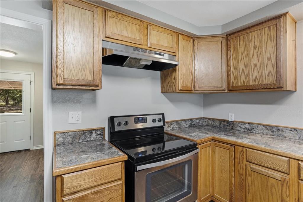 106 Cardinal Lane Pottsboro, TX 75076 - Photo 10 of 29 a kitchen with granite countertop cabinets stainless steel appliances and a counter space