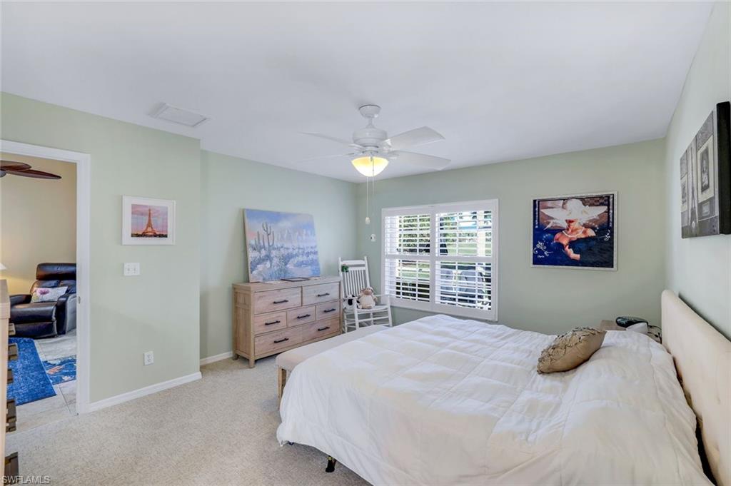 914 Augusta Boulevard, Unit 7 Naples, FL 34113 - Photo 14 of 32 Bedroom with light carpet, ceiling fan, and baseboards