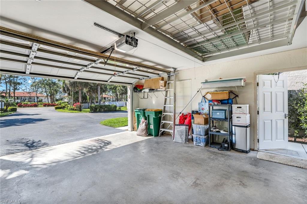 914 Augusta Boulevard, Unit 7 Naples, FL 34113 - Photo 22 of 32 Garage featuring a garage door opener
