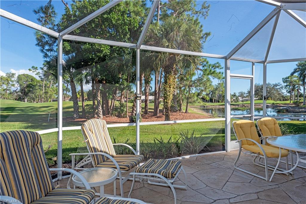 914 Augusta Boulevard, Unit 7 Naples, FL 34113 - Photo 24 of 32 Sunroom featuring a water view