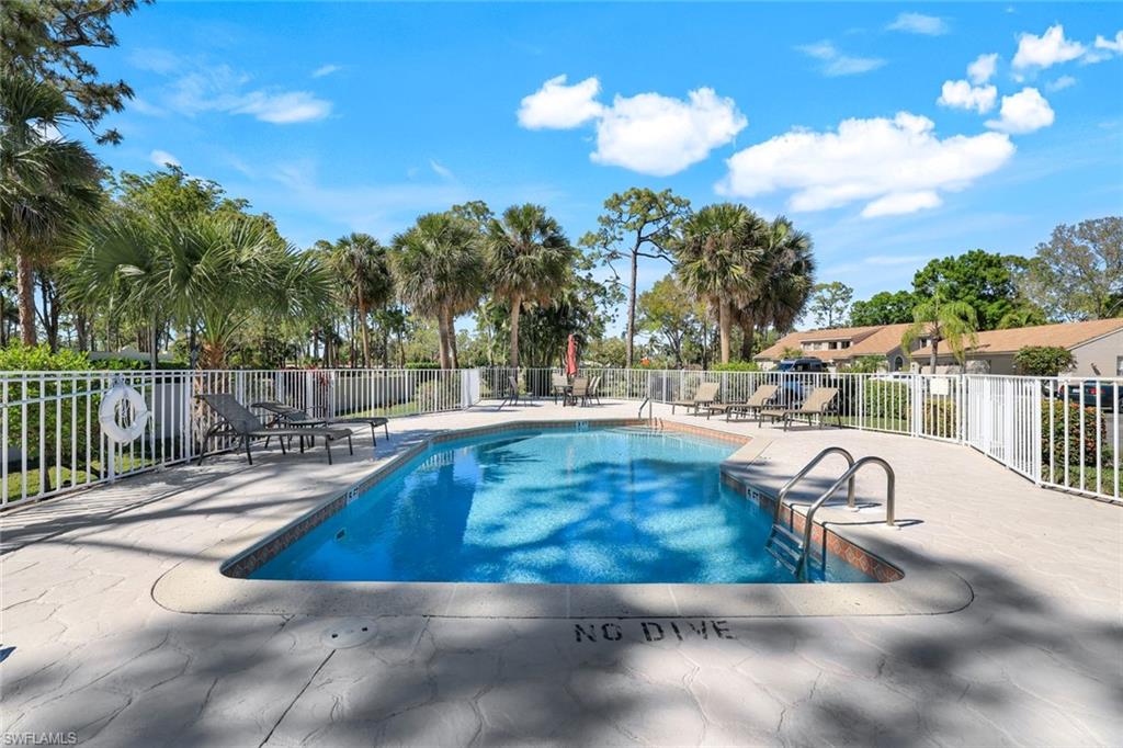 914 Augusta Boulevard, Unit 7 Naples, FL 34113 - Photo 28 of 32 Community pool featuring a patio and fence