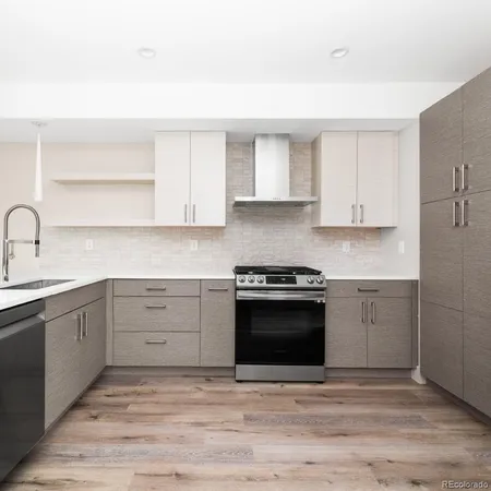 a kitchen with stainless steel appliances granite countertop a stove and a sink