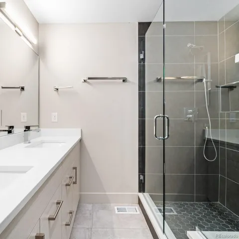 a bathroom with a shower sink and mirror