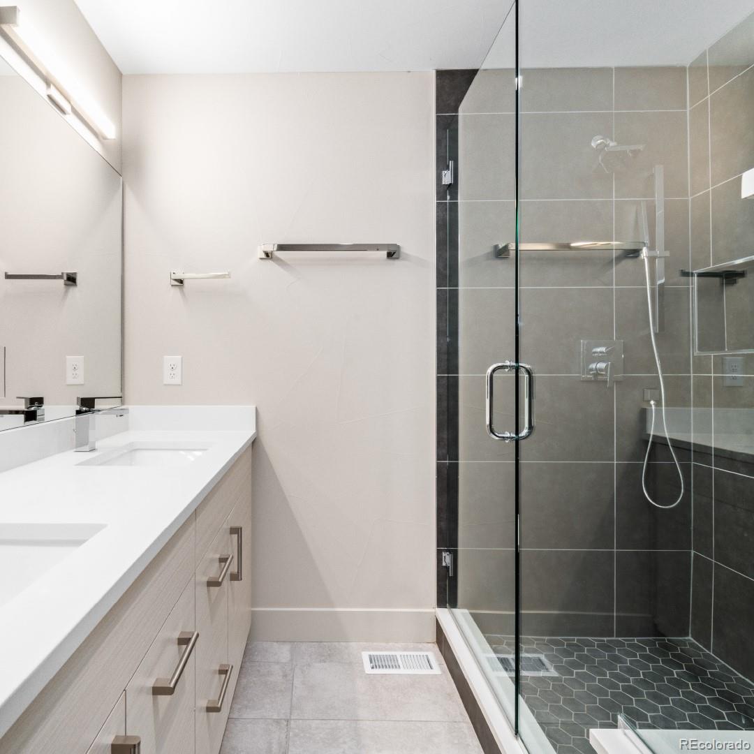 1318 Yates Street Denver, CO 80204 - Photo 5 of 14 a bathroom with a shower sink and mirror