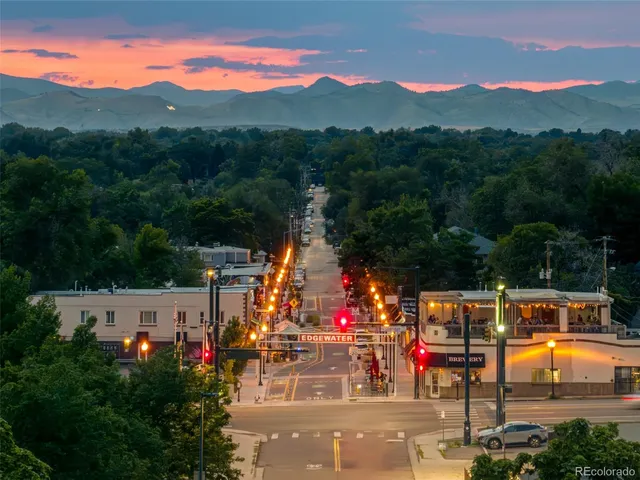 an aerial view of residential houses with outdoor space and street view