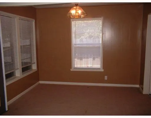 a view of wooden floor and windows in a room