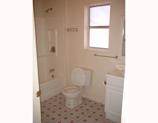 a bathroom with a toilet a sink and a window
