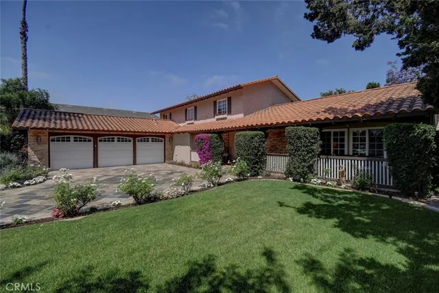 a front view of a house with a garden and plants