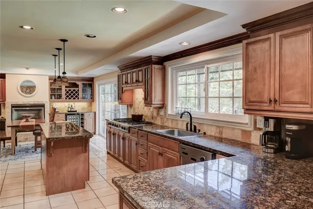 a kitchen with stainless steel appliances granite countertop a stove and a refrigerator