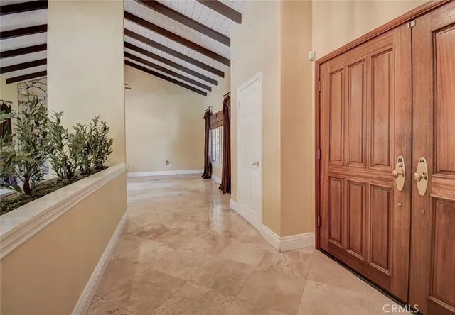 a living room with furniture a large window and dining table