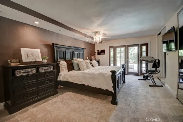 a large bed sitting in a room next to a window