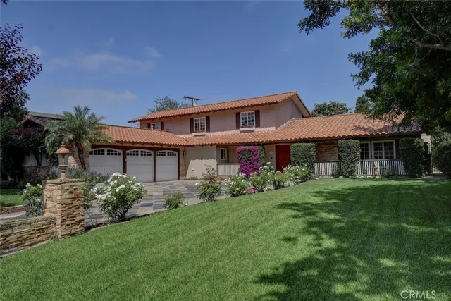 a front view of a house with a garden
