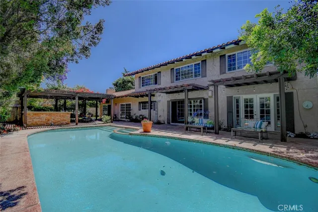 a view of a house with backyard porch and sitting area