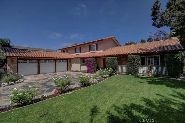 a front view of a house with a garden and yard
