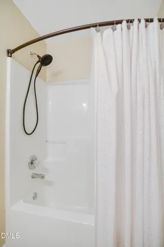 a bathroom with a shower and a shower