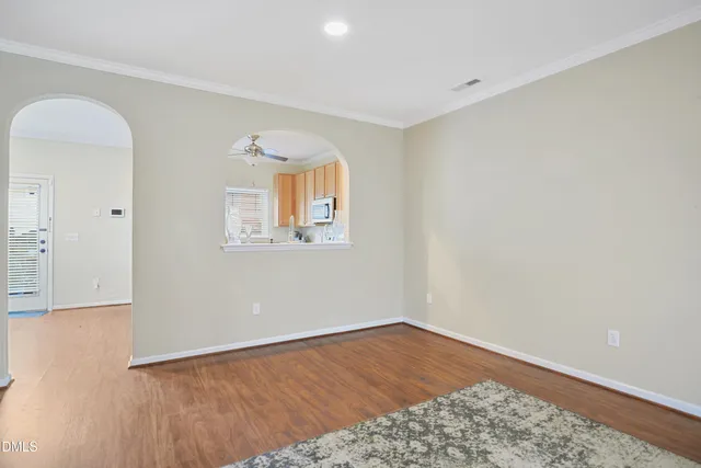 an empty room with wooden floor and a window