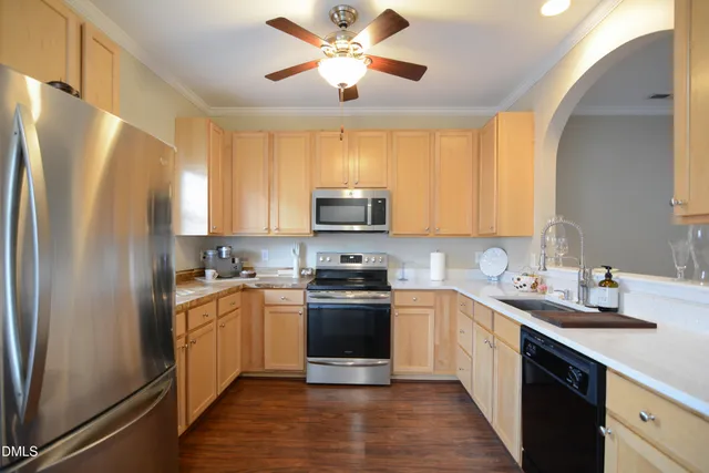 a kitchen with a sink stainless steel appliances and cabinets