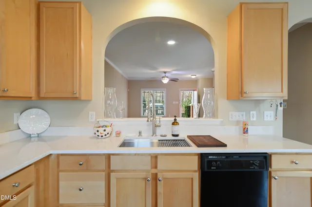 a kitchen with granite countertop a sink and cabinets