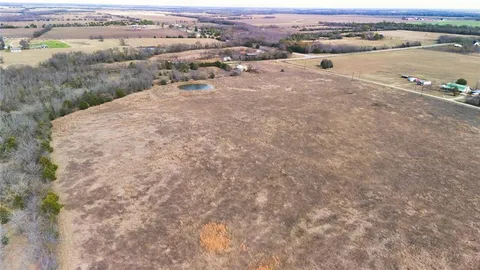 an aerial view of a houses with a yard