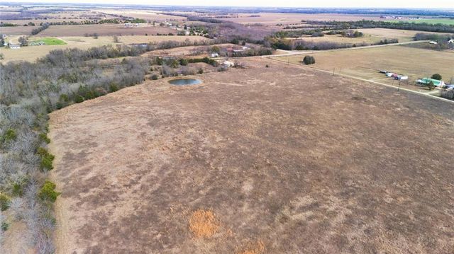 an aerial view of a houses with a yard