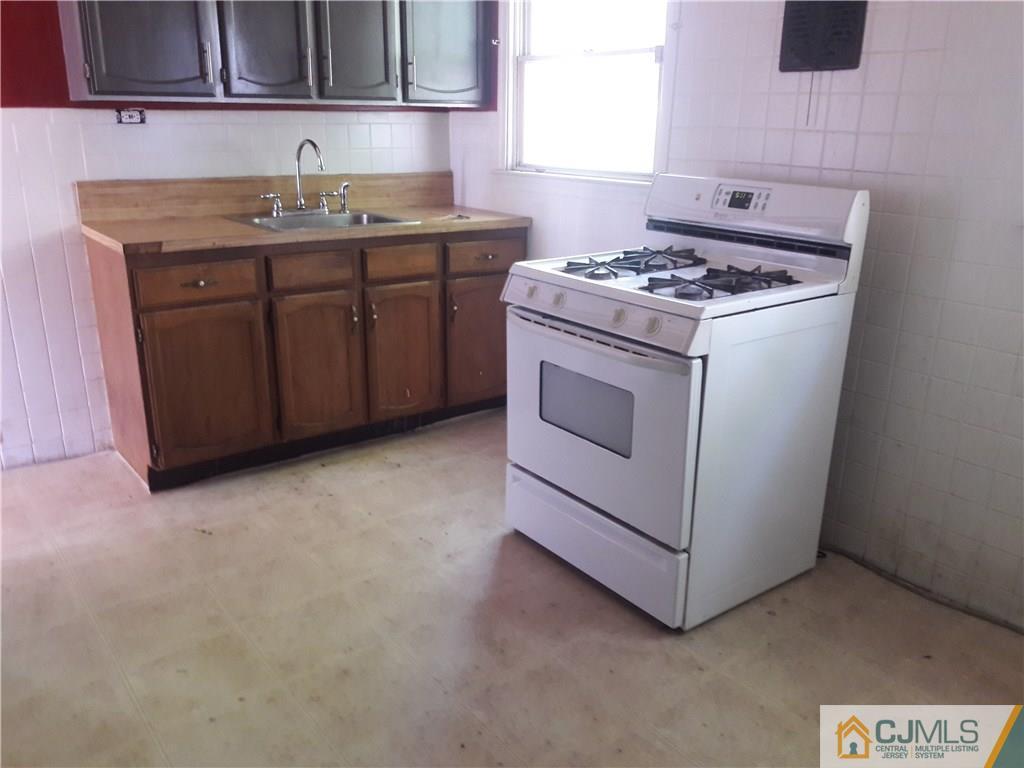 4 Sine Road Edison, NJ 08817 - Photo 12 of 25 a kitchen with granite countertop a sink and a stove