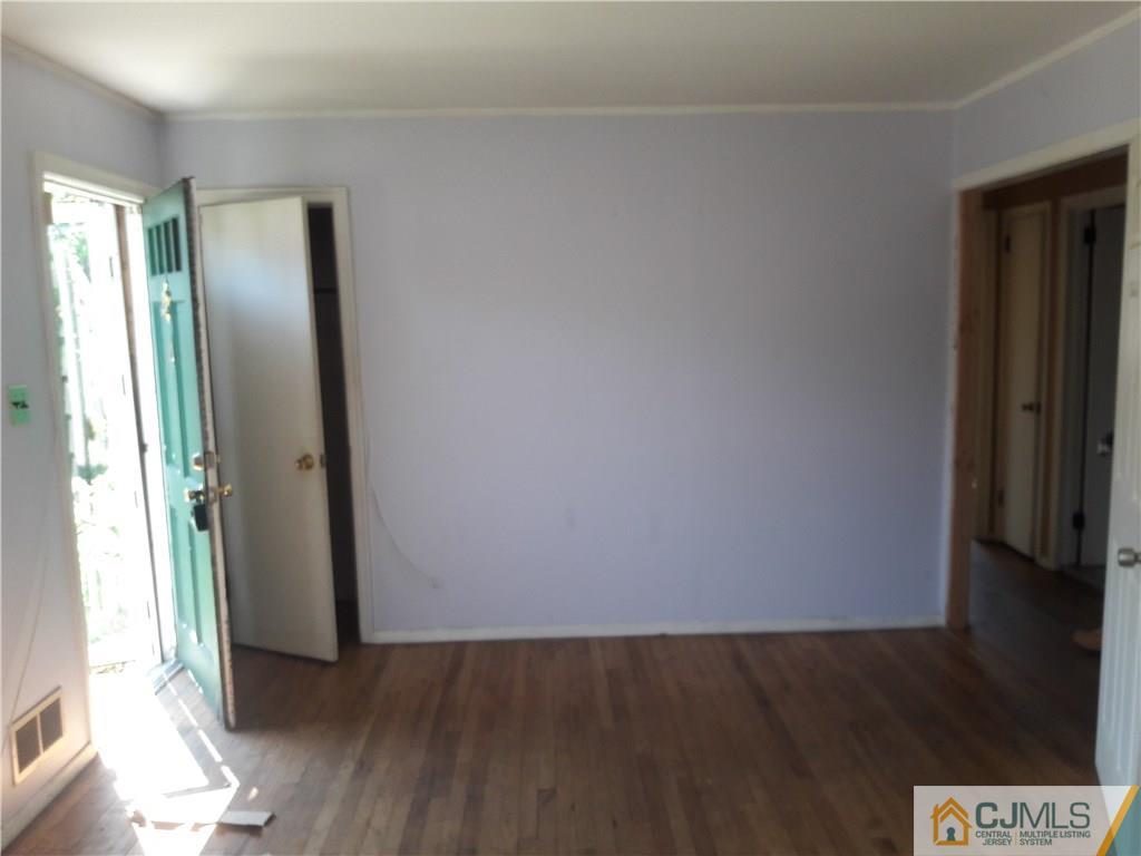 4 Sine Road Edison, NJ 08817 - Photo 5 of 25 an empty room with wooden floor and windows