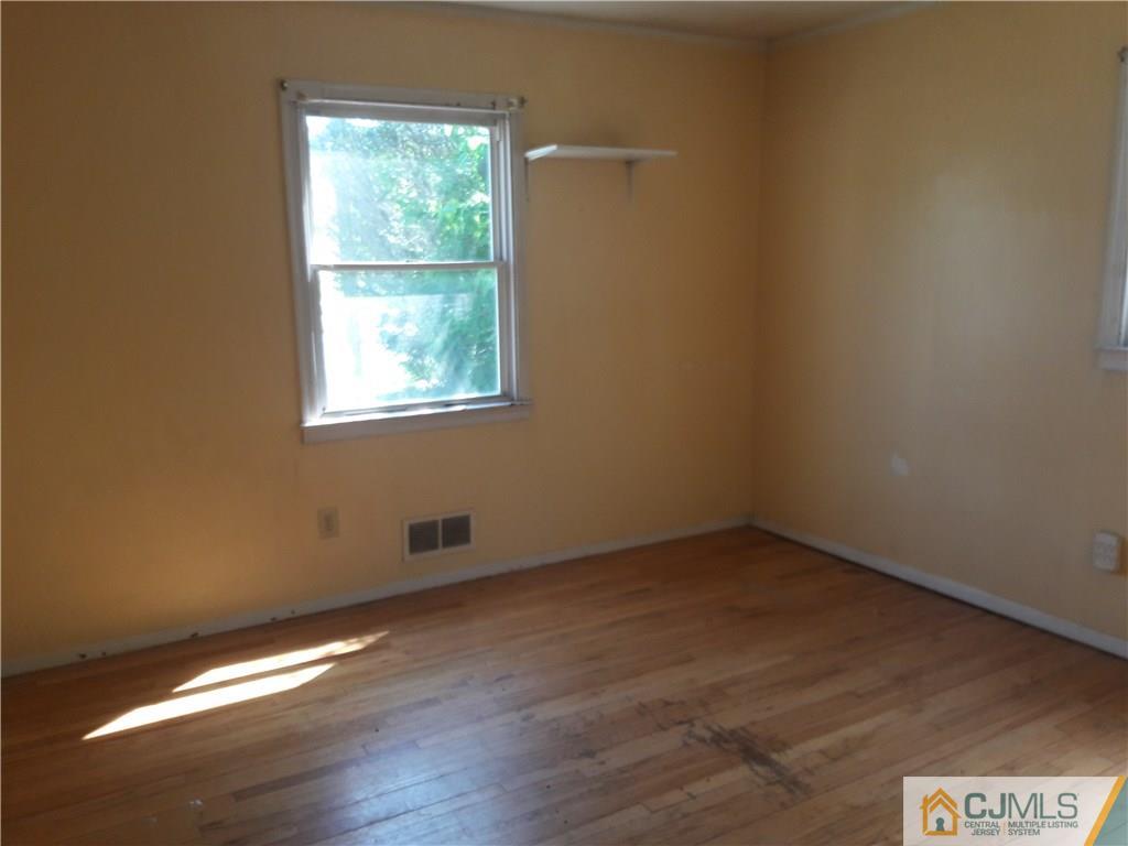 4 Sine Road Edison, NJ 08817 - Photo 6 of 25 an empty room with wooden floor and windows