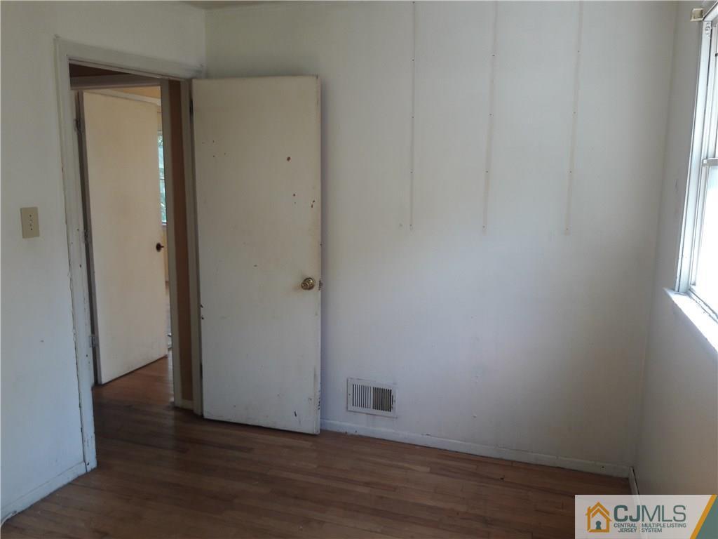 4 Sine Road Edison, NJ 08817 - Photo 10 of 25 a view of an empty room with wooden floor and a window