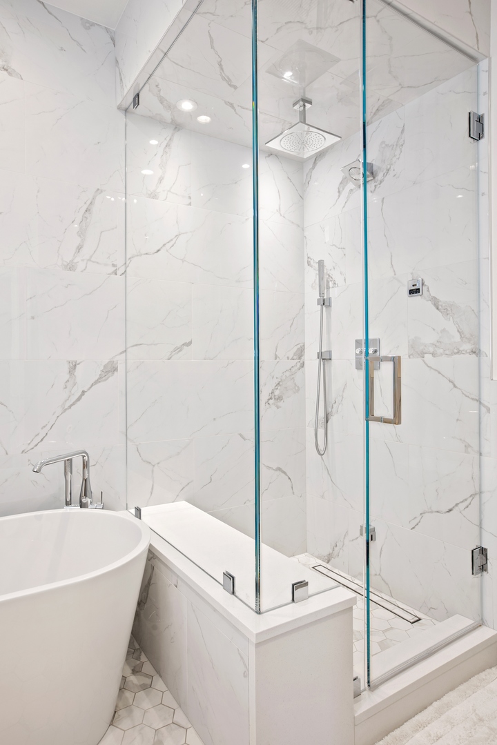 39 North Morgan Street, Unit 4 Chicago, IL 60607 - Photo 16 of 24 a bathroom with a white bath tub sitting next to shower