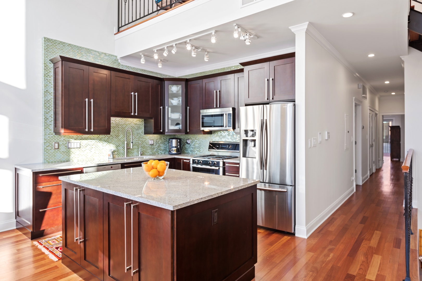 39 North Morgan Street, Unit 4 Chicago, IL 60607 - Photo 6 of 24 a kitchen with stainless steel appliances granite countertop a refrigerator a sink dishwasher a stove and white countertops with wooden floor