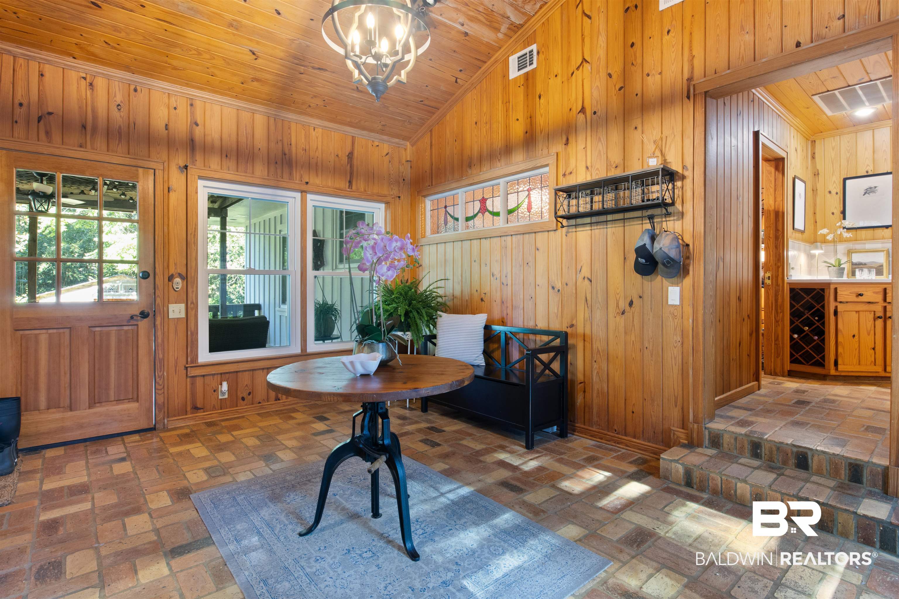 15100 Vasko Road Silverhill, AL 36576 - Photo 7 of 51 Foyer with wood walls, vaulted ceiling, an inviting chandelier, and wooden ceiling and back door leading to covered patio and hot tub.