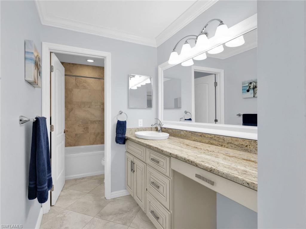 750 West Elkcam Circle, Unit 107 Marco Island, FL 34145 - Photo 12 of 33 Master Bathroom with vanity, crown molding, bathtub / shower combination, and light tile patterned floors
