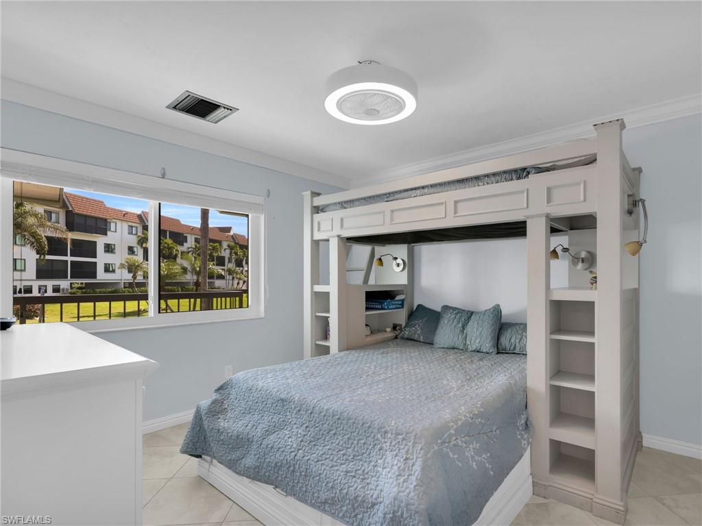 750 West Elkcam Circle, Unit 107 Marco Island, FL 34145 - Photo 13 of 33 Bedroom with ornamental molding and light tile patterned floors