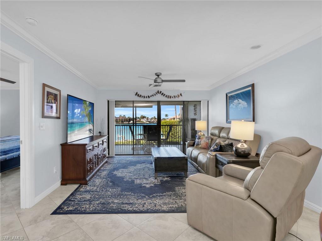 750 West Elkcam Circle, Unit 107 Marco Island, FL 34145 - Photo 28 of 33 Living area with ceiling fan, crown molding, and light tile patterned floors