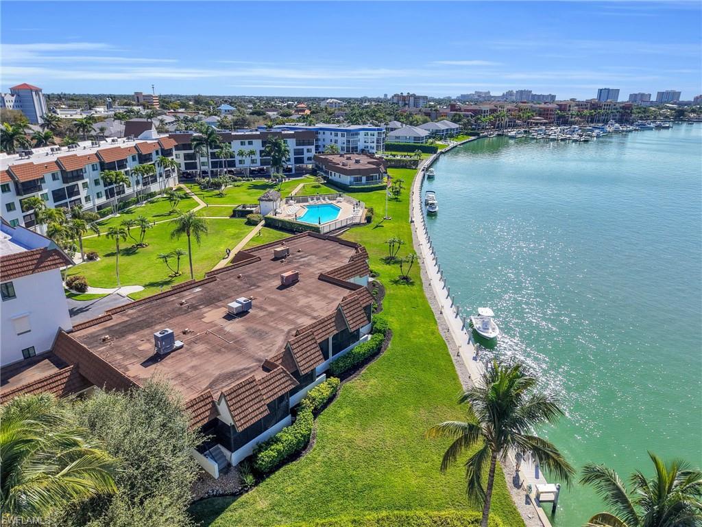 750 West Elkcam Circle, Unit 107 Marco Island, FL 34145 - Photo 3 of 33 View of urban area with a large body of water and a pool