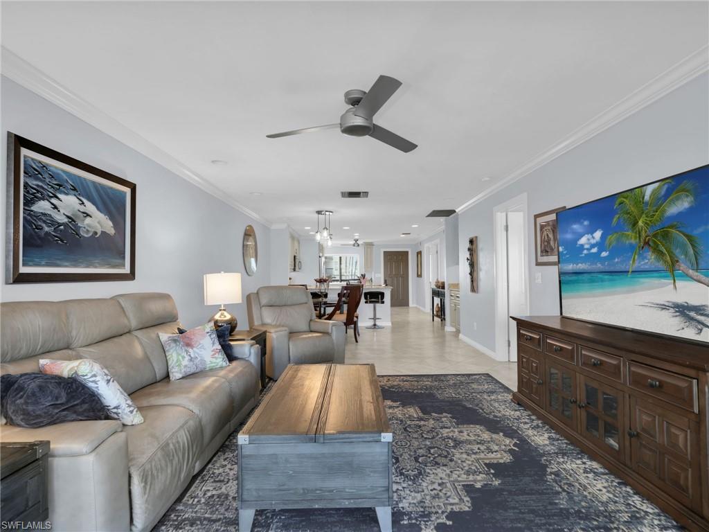 750 West Elkcam Circle, Unit 107 Marco Island, FL 34145 - Photo 29 of 33 Living area featuring ornamental molding and ceiling fan