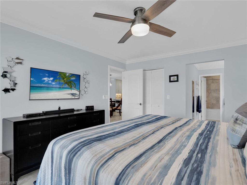 750 West Elkcam Circle, Unit 107 Marco Island, FL 34145 - Photo 31 of 33 Bedroom with crown molding, a closet, a ceiling fan, and connected bathroom